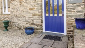 A stone building with a blue door and a sign reading "WHEAL HART". - Wheal Hart (Newquay)