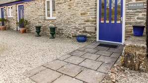 A stone building with a blue door and windows, labeled "WHEAL HART". - Wheal Hart (Newquay)