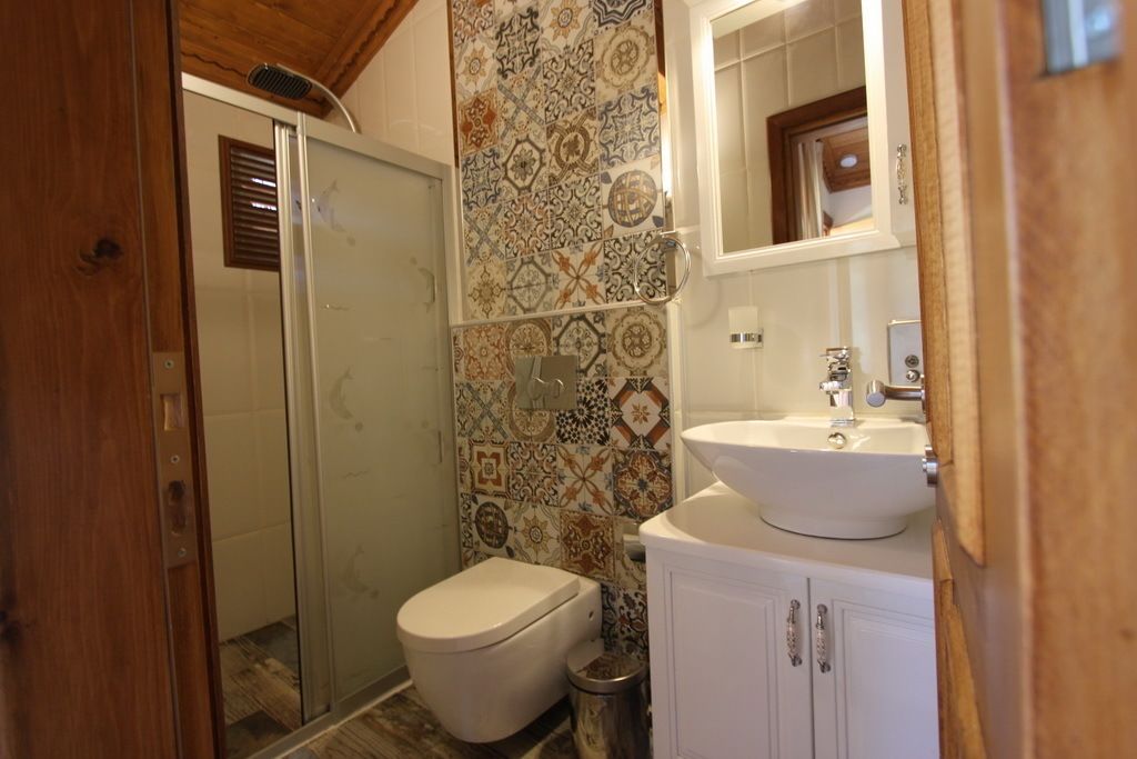 A bathroom with a shower, toilet, and sink.