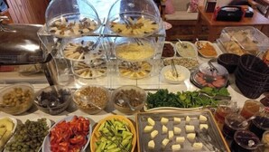 A buffet with various food items and drinks. - Elly's Home (Datça)