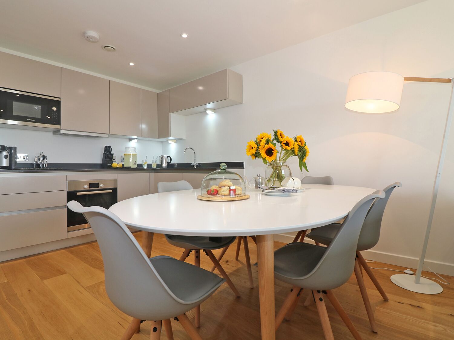 A modern kitchen with a dining area.