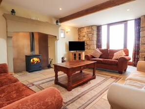 Relax by the fireplace in this inviting living room with a comfortable sofa and flat-screen TV.