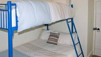 A bunk bed with a blue frame, white bedding, and a patterned pillow.
