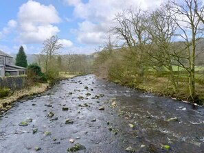A river with rocks and trees on both sides.