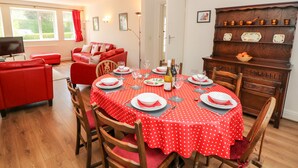 A dining area with a red polka dot tablecloth, wooden chairs, and a chandelier. - Loose Hill Lea (Hope Valley)