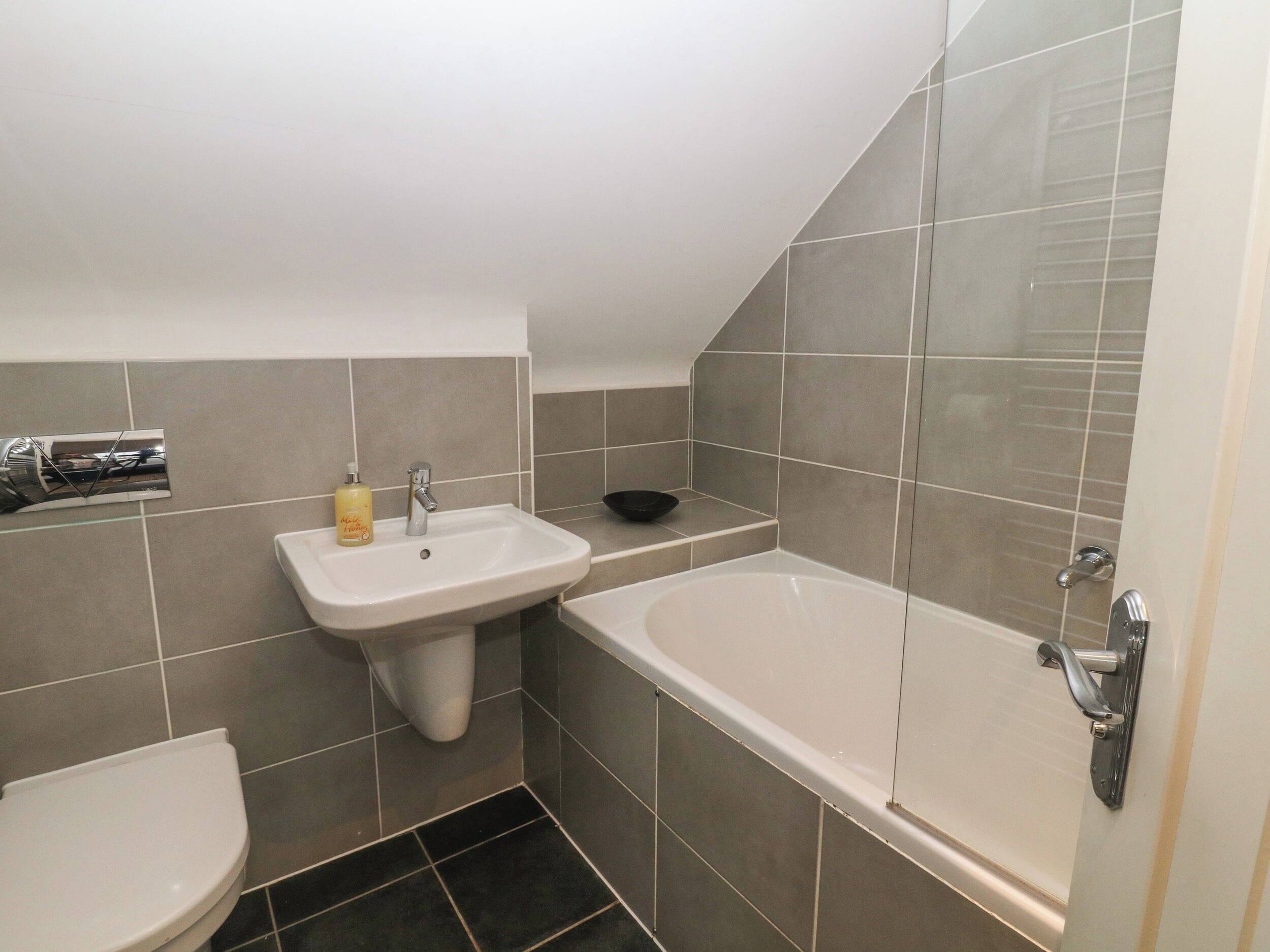 A bathroom with a sink, toilet, and bathtub.
