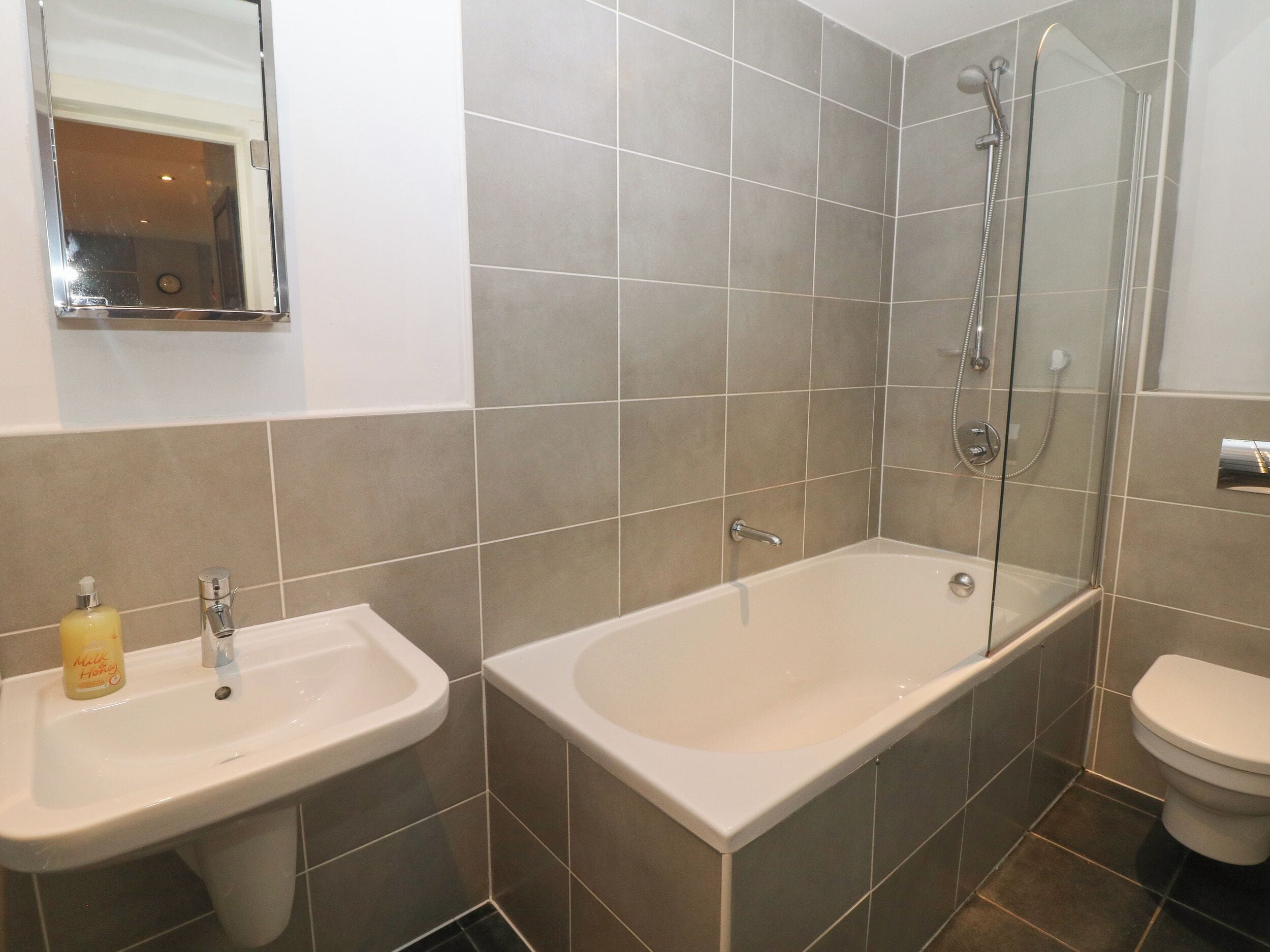 A bathroom with a bathtub, a sink, and a toilet.