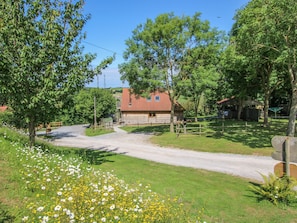 Surrounded by lush greenery and wildflowers, this cabin offers a serene retreat.
