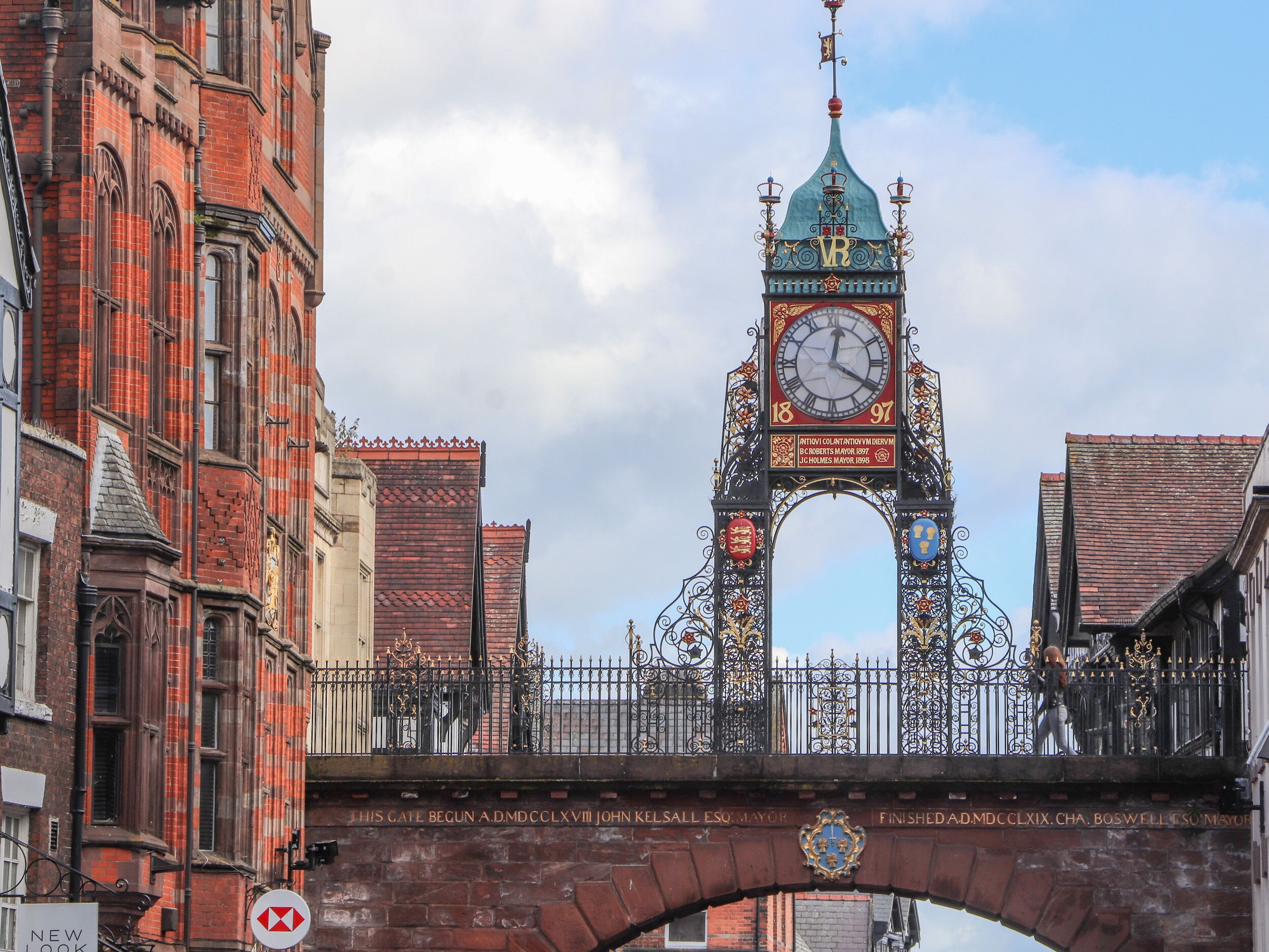 A historic bridge with ornate ironwork and a clock tower.