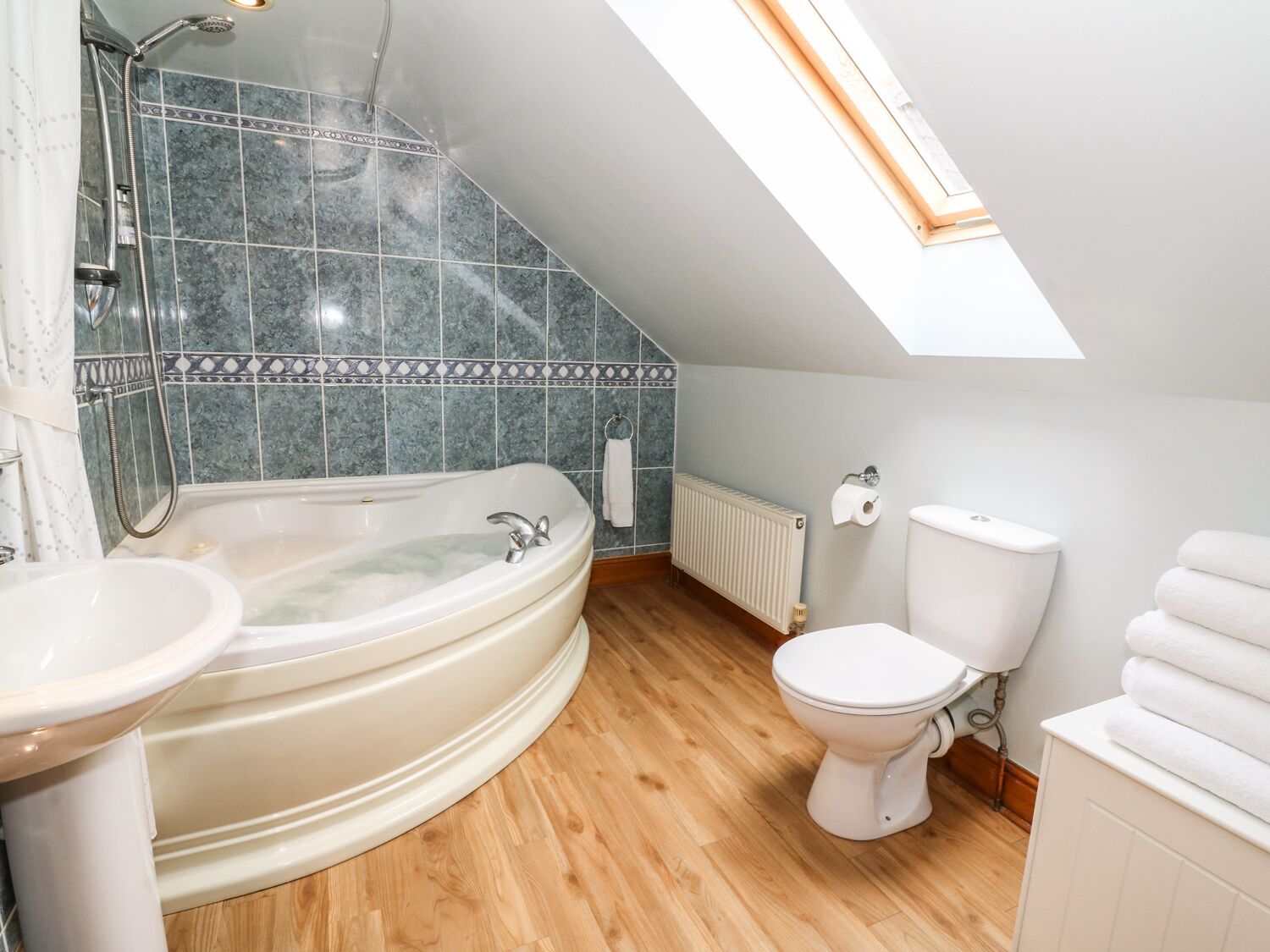 A modern bathroom with a freestanding bathtub, a toilet, and a sink.
