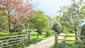A gravel path leading through a lush garden with wooden gates labeled 'Highcroft', 'The Fold', and 'The Bothy'. - Highcroft (Stratford-upon-Avon)