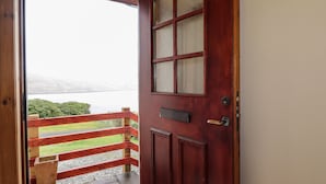A wooden door with a glass panel, a metal handle, and a keyhole. - Mackenzies Peak (Sconser)