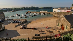 A coastal town with a marina, sandy beach, and stone buildings. - Cann Ross (Tenby)