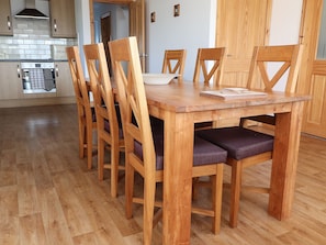 Enjoy meals in this cozy dining area with a wooden table and six comfortable chairs.