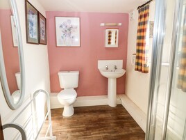 A bathroom with a toilet, sink, and shower curtain.