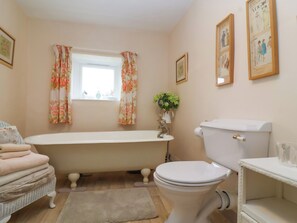 A bathroom with a bathtub, toilet, and sink. - Church Farmhouse (Chard)