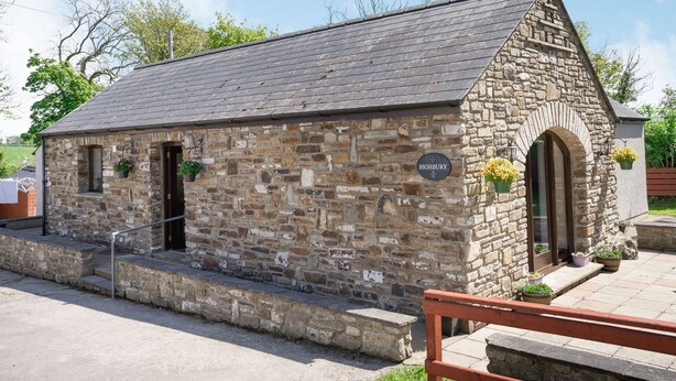 A stone building with a sign reading "Highbury."
