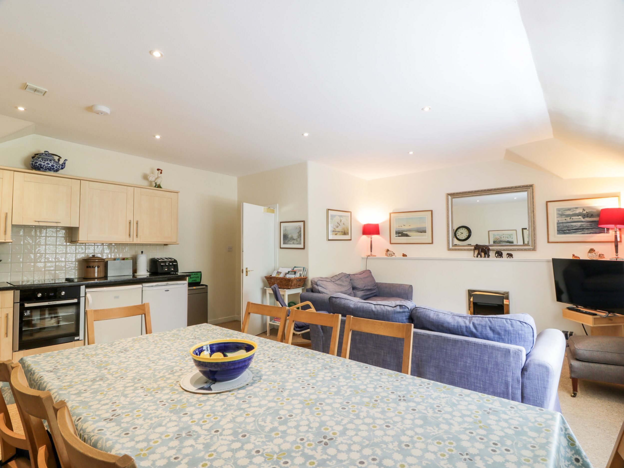 Un espacio habitable compacto con comedor, kitchenette y zona de estar.
