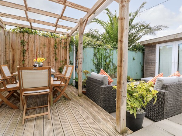 A wooden deck with a pergola, wicker furniture, and potted plants. - Chy Kerris, Carbis Bay (St Ives)