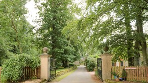 A gated entrance to a property with a pathway leading to a building. - Gardener's Cottage (Duns)