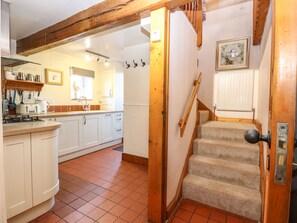 Kitchen area with modern gas stove, sink, and ample storage.