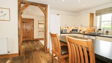 Fridge, dishwasher, high chair, cookware/dishes/utensils