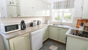 Cottage | Private kitchen | Stovetop, dishwasher, highchair, cookware/dishes/utensils