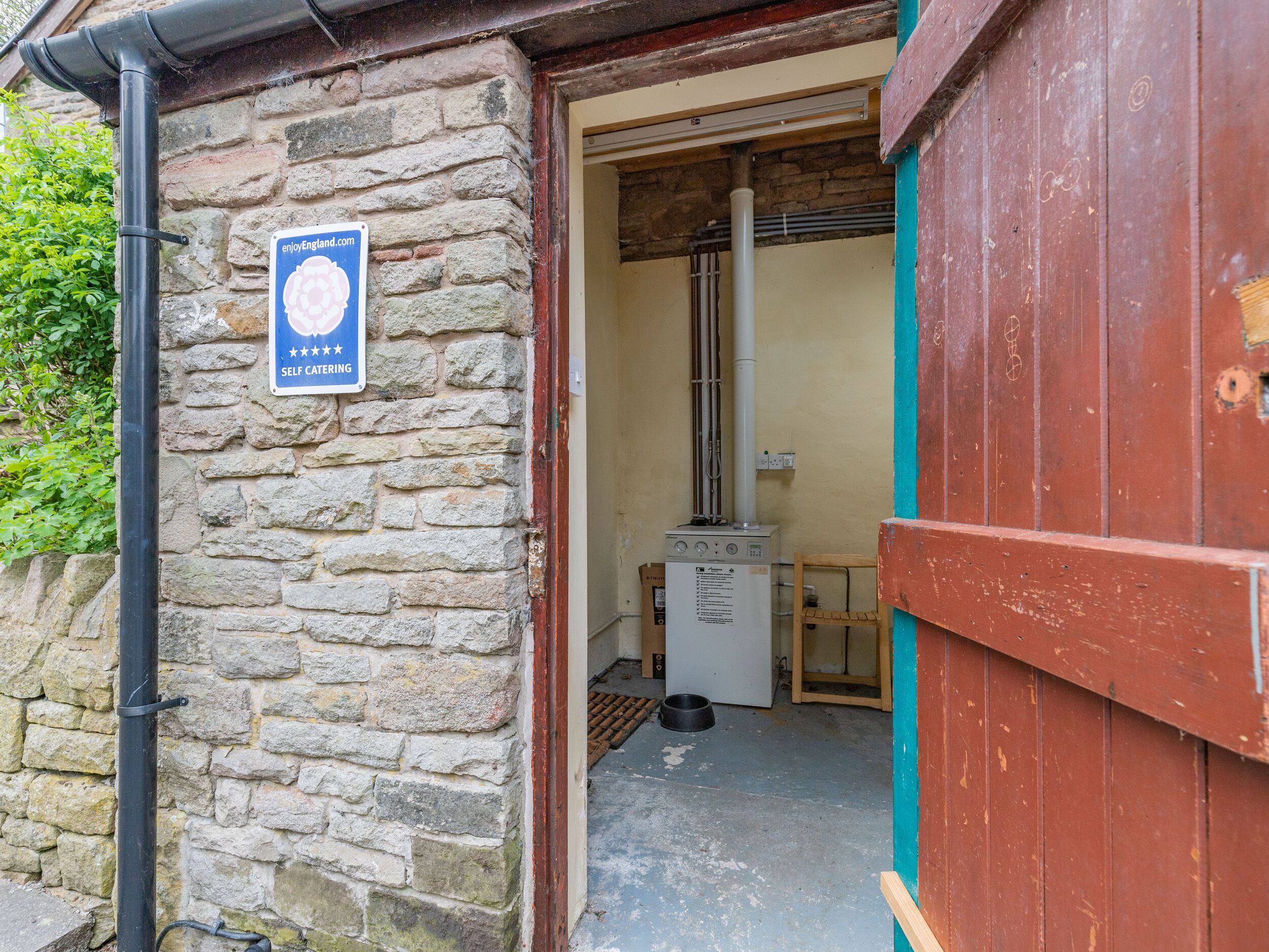 A stone building with a sign indicating self-catering facilities.