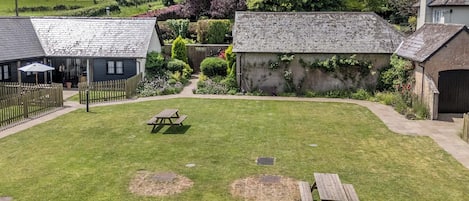 A well-maintained garden with a picnic table and a small play area.