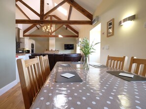 Enjoy meals in this inviting dining area with a large round table and comfortable seating.