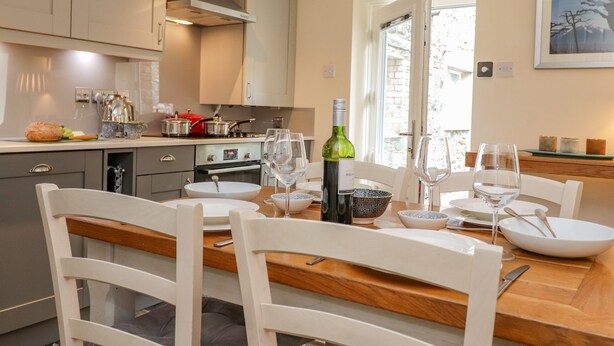 A modern kitchen with a dining area. - Maple Cottage (Keswick)