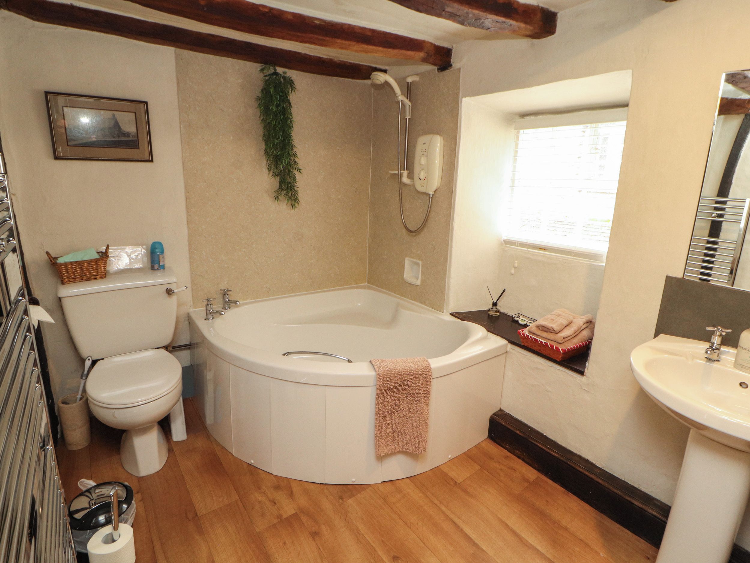 A bathroom with a bathtub, toilet, and sink.