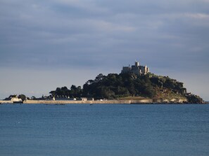 A castle on a hill overlooking a body of water. - The Penthouse (Penzance)