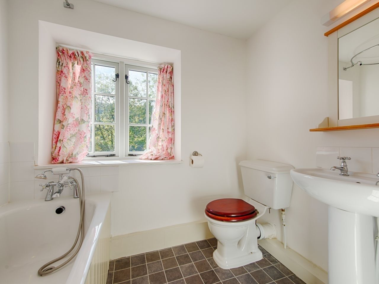 A bathroom with a bathtub, toilet, and sink.