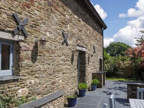 A stone building with a window, a door, and a stone wall. - The Hay Barn (Totnes)
