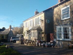 Traditional pub with a classic pitched roof and chimney, offering a cozy atmosphere.