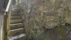 A stone staircase leading up to a wooden door. - April Cottage (Helston)