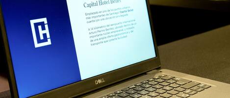 A laptop displaying a hotel name and description.