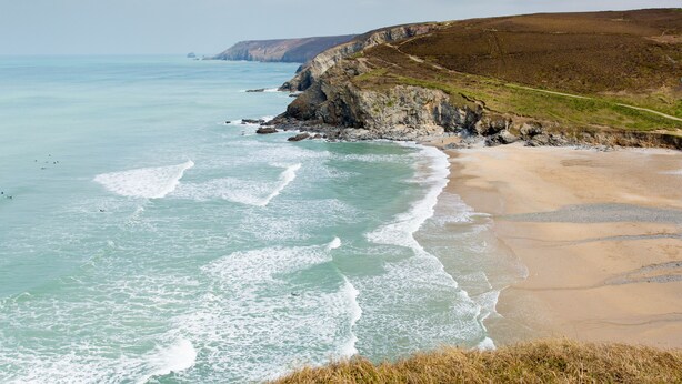 A coastal landscape with a sandy beach and rocky cliffs. - Moor View Chapel (Camelford)