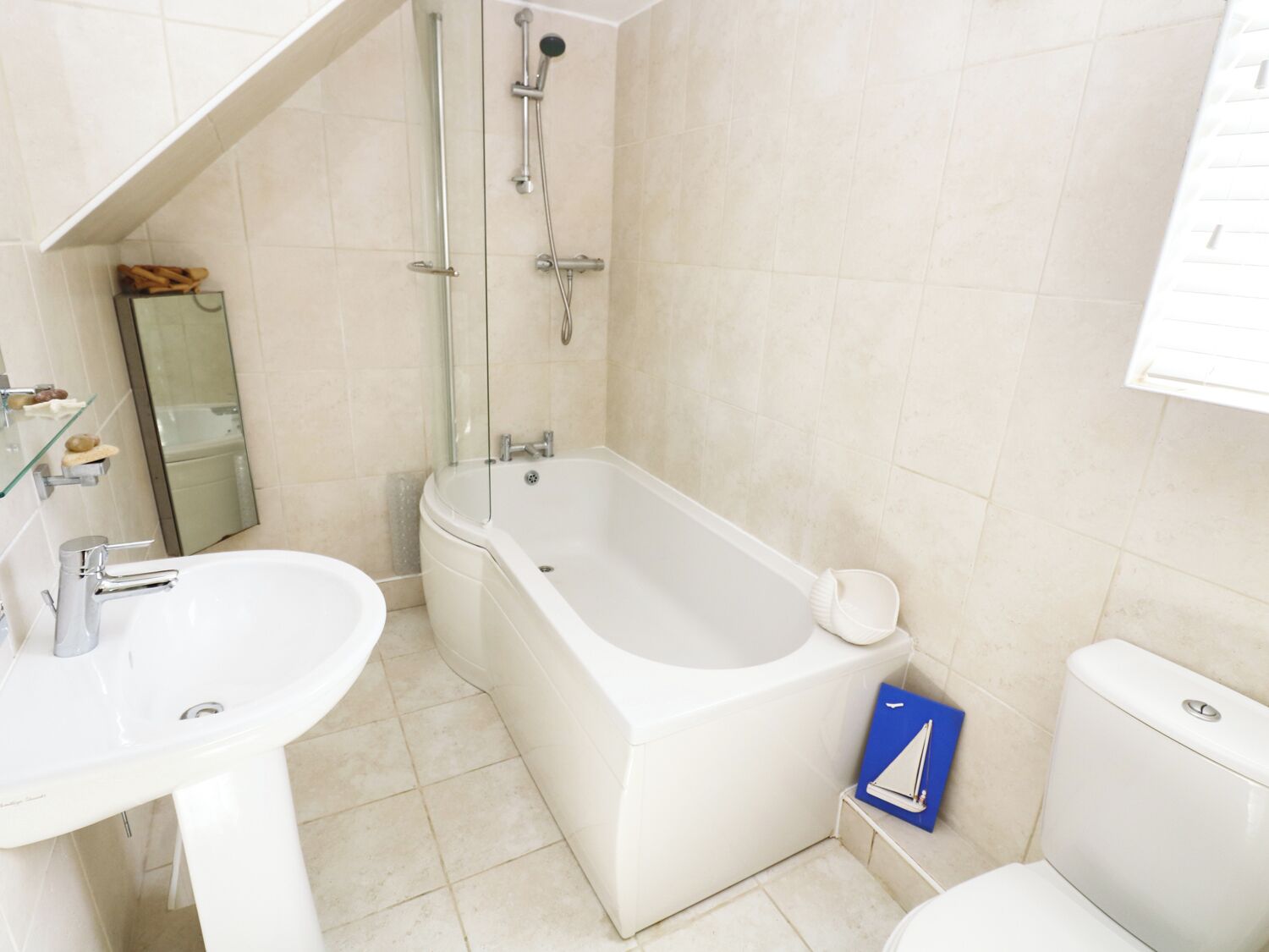 A bathroom with a bathtub, a sink, and a toilet.