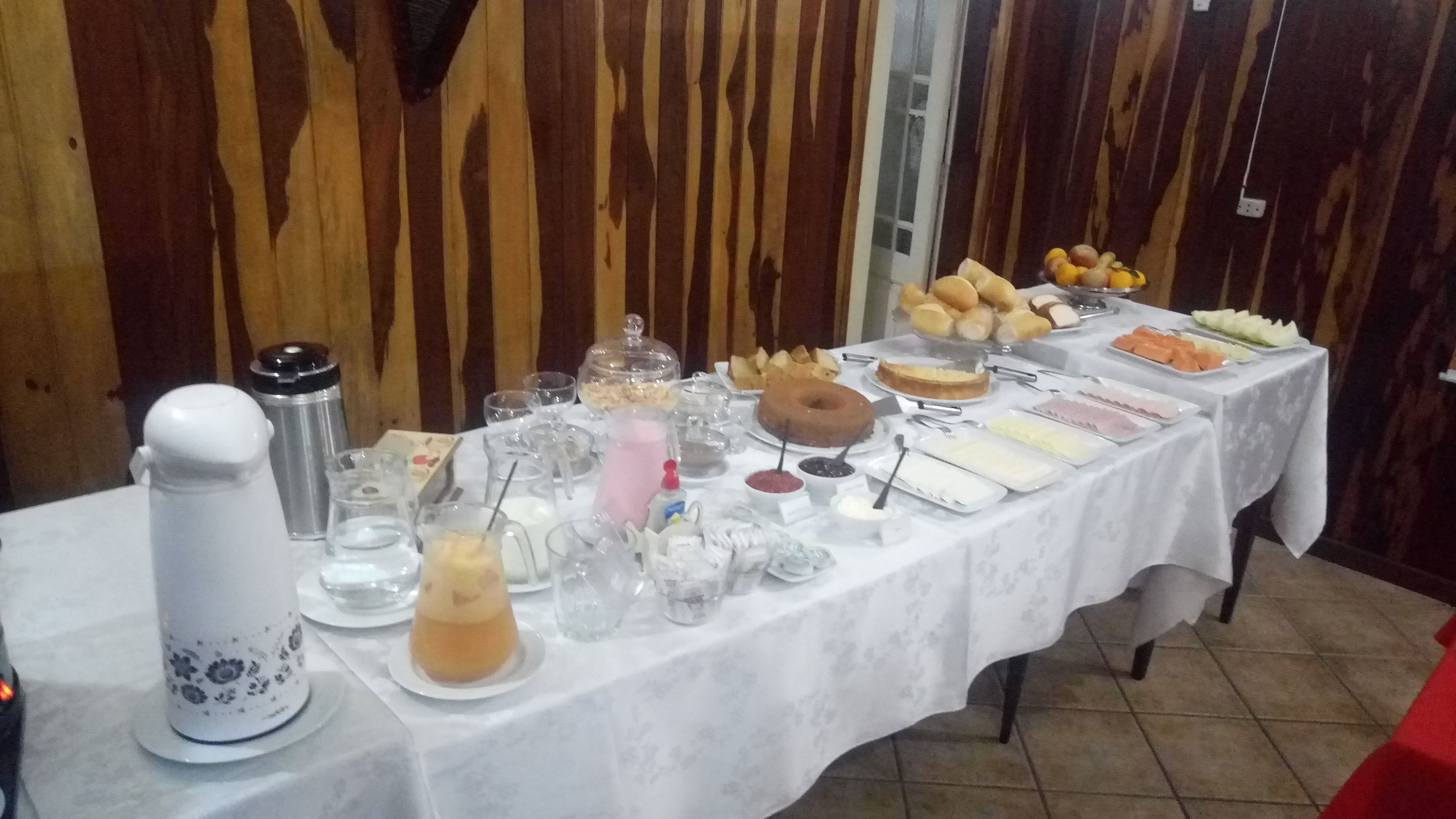A buffet table with various food items and beverages.