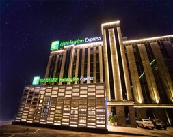 A Holiday Inn Express hotel with a modern facade, large windows, and a prominent sign.