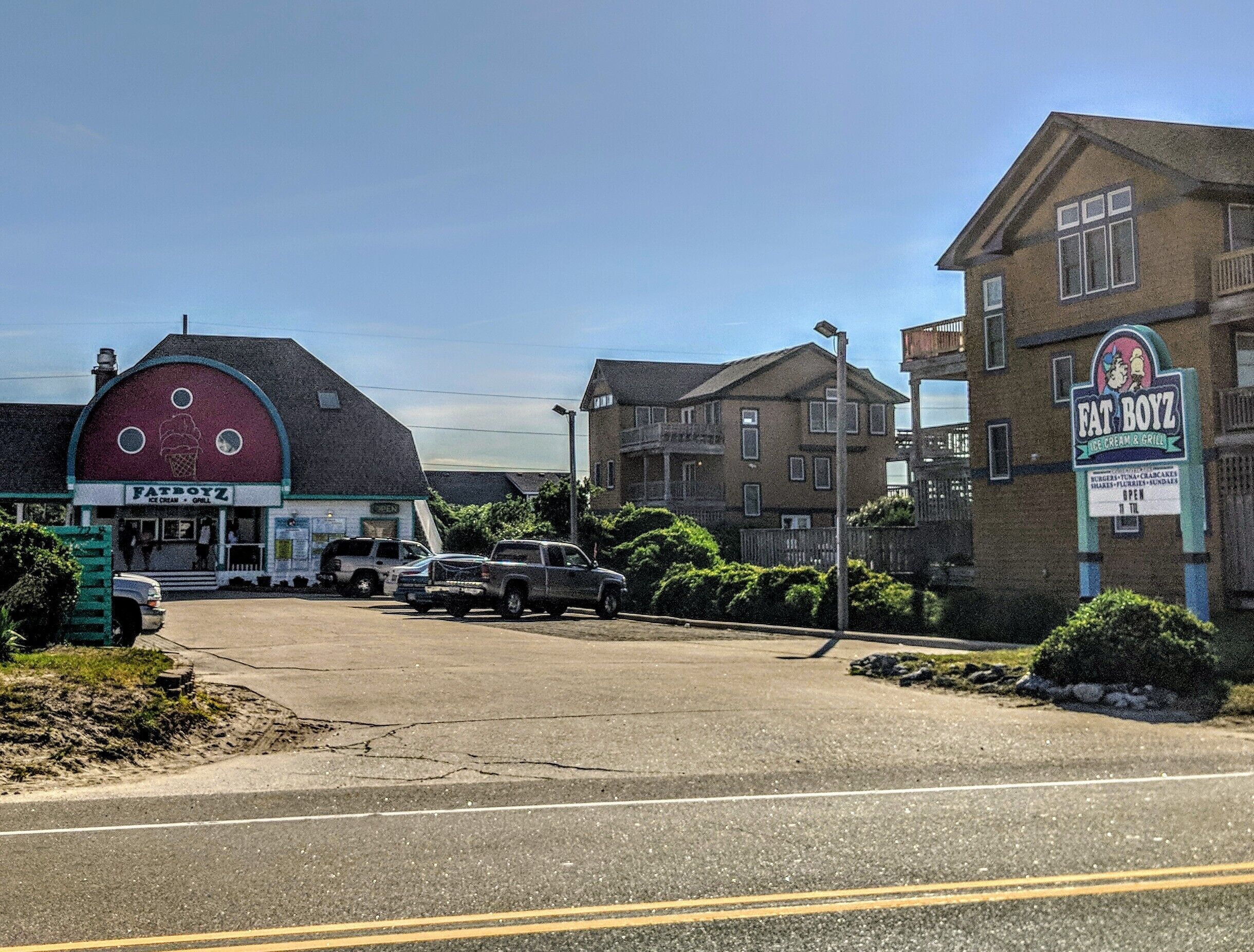 A street view with a red barn-like building labeled "FateBoyz Ice Cream & Grill" and another building with a sign "OPEN".