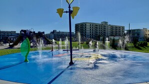 A water feature with multiple fountains in a park setting.