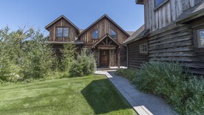 A rustic log cabin with a prominent front door and a 'WELCOME' sign. - Fly Fisherman's Lodge on the Bitterroot River,  Lolo Mt (Lolo)