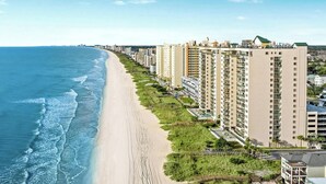 A coastal residential area with high-rise buildings, a beach, and a clear sky. - Naturally Beautiful Unit, Recliner, Indoor Pool | Ocean Bay Club - 807 (North Myrtle Beach)