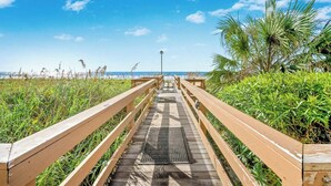 A wooden boardwalk leading to a beach with a clear sky. - Naturally Beautiful Unit, Recliner, Indoor Pool | Ocean Bay Club - 807 (North Myrtle Beach)