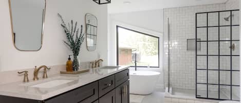 Bathtub, towels, shampoo, toilet paper
