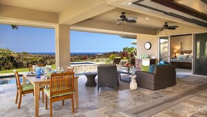 A covered outdoor area with a pool, dining table, chairs, and lounge seating. - BIG ISLAND PARADISE-private lanai -pool/spa/low golf rates/access to #1 beaches  (Kamuela)