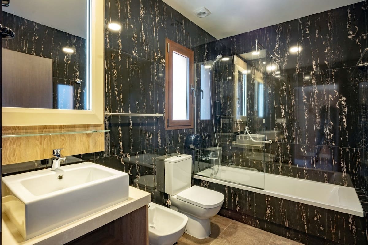 designer toiletries, hair dryer, bidet, towels